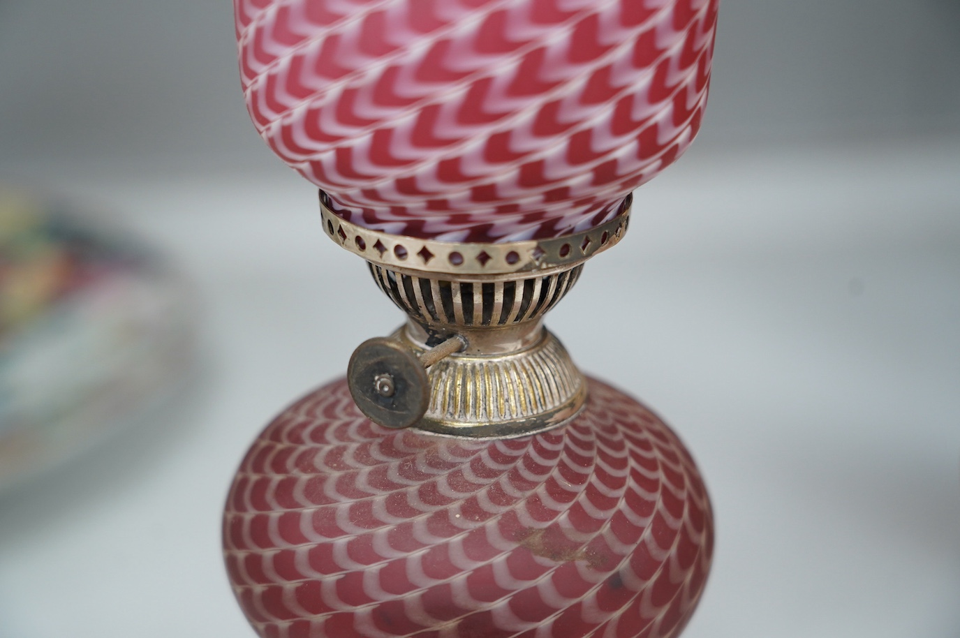 A pair of electroplate and ruby glass oil lamps, 35cm. Condition - good, not tested